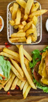 Top view of a delicious burger and fries on a rustic wooden board.